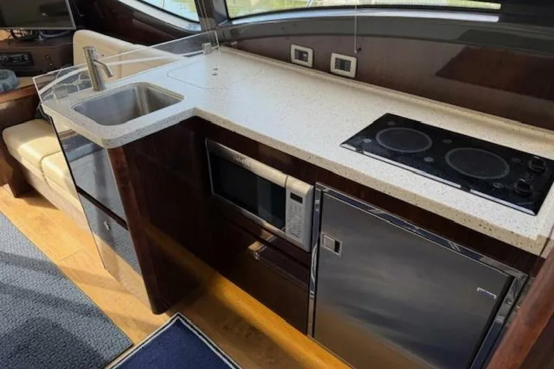 Slide: The Image of Luxurious 2016 Sea Ray Sundancer 400 yacht kitchen with modern appliances and sleek design. - 5
