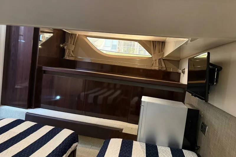 Slide: The Image of Interior cabin of 2016 Sea Ray Sundancer 400 yacht with twin beds and window. - 7