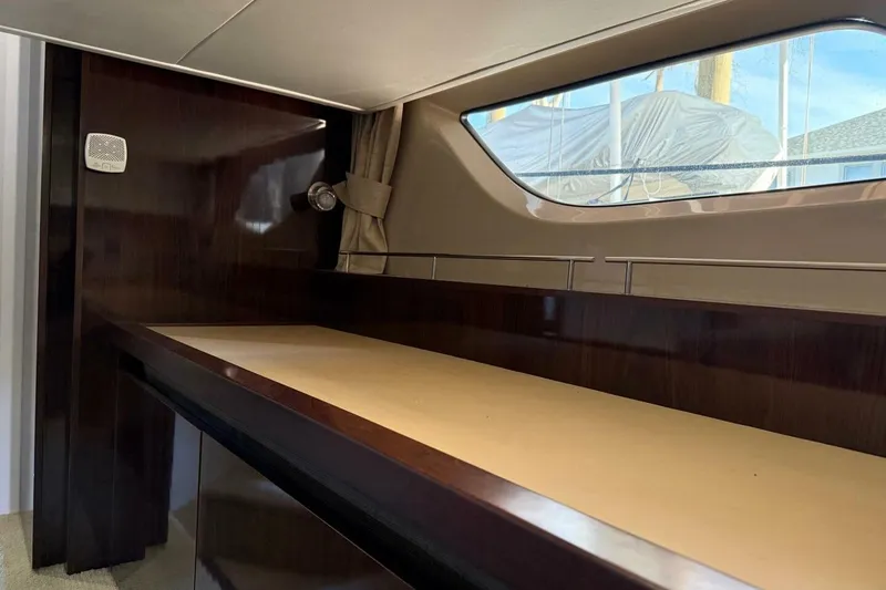 Slide: The Image of Interior of 2016 Sea Ray Sundancer 400 yacht with wooden finish and window view. - 8