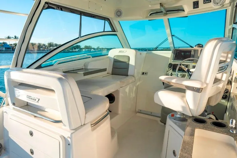 Slide: The Image of Interior of 2014 Boston Whaler 315 Conquest boat with helm and seating area. - 19