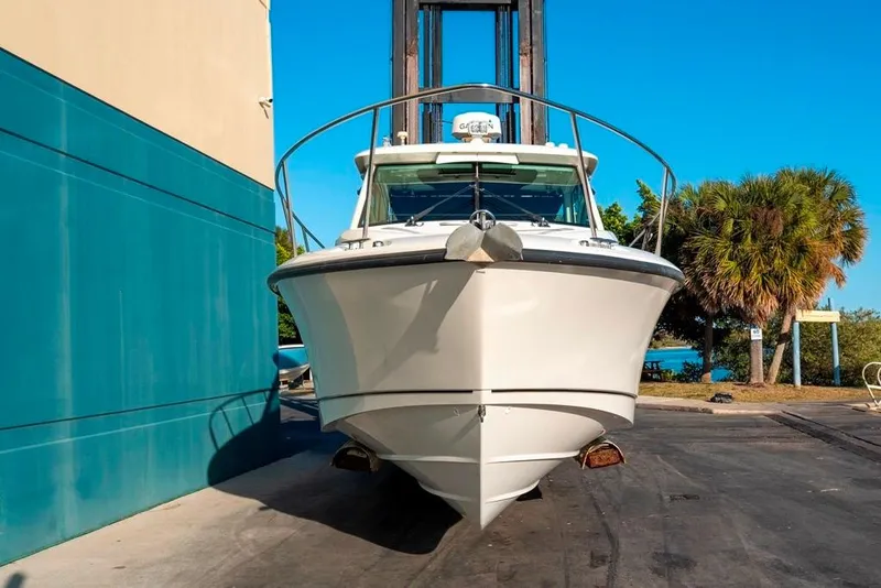 Slide: The Image of 2014 Boston Whaler 315 Conquest boat docked, front view, sunny day. - 2
