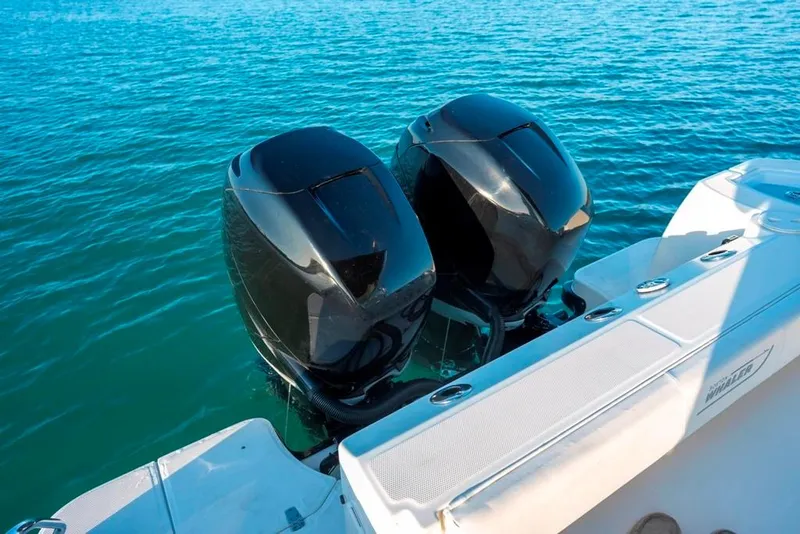 Slide: The Image of Twin outboard engines on a 2014 Boston Whaler 315 Conquest in blue waters. - 25