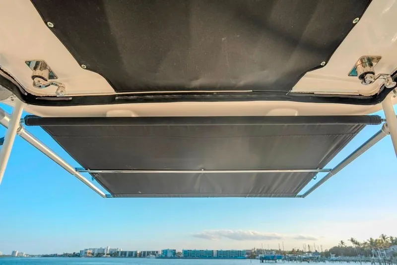 Slide: The Image of 2014 Boston Whaler 315 Conquest boat canopy with ocean view in background. - 30