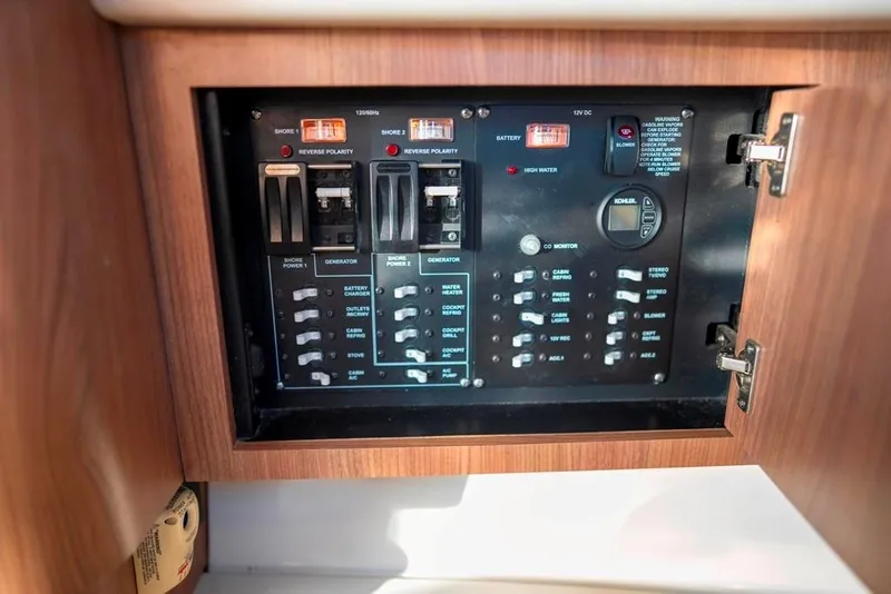 Slide: The Image of Electrical control panel on 2014 Boston Whaler 315 Conquest boat, featuring switches and indicators. - 32