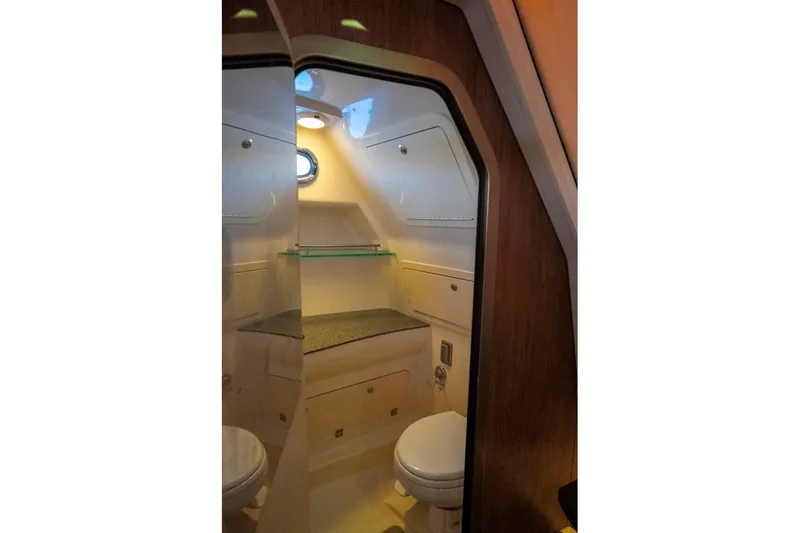 Slide: The Image of 2014 Boston Whaler 315 Conquest boat bathroom interior with modern amenities. - 36