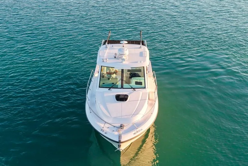 Slide: The Image of 2014 Boston Whaler 315 Conquest boat on calm blue water, aerial view. - 4