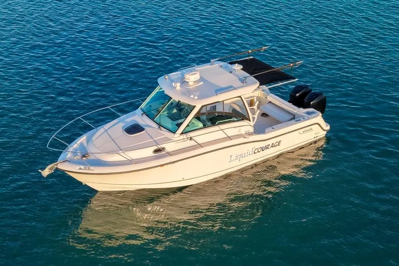 Slide: The Image of 2014 Boston Whaler 315 Conquest boat on calm blue water. - 6