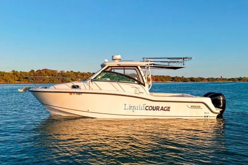 Slide: The Image of 2014 Boston Whaler 315 Conquest boat on calm water, side view. - 9