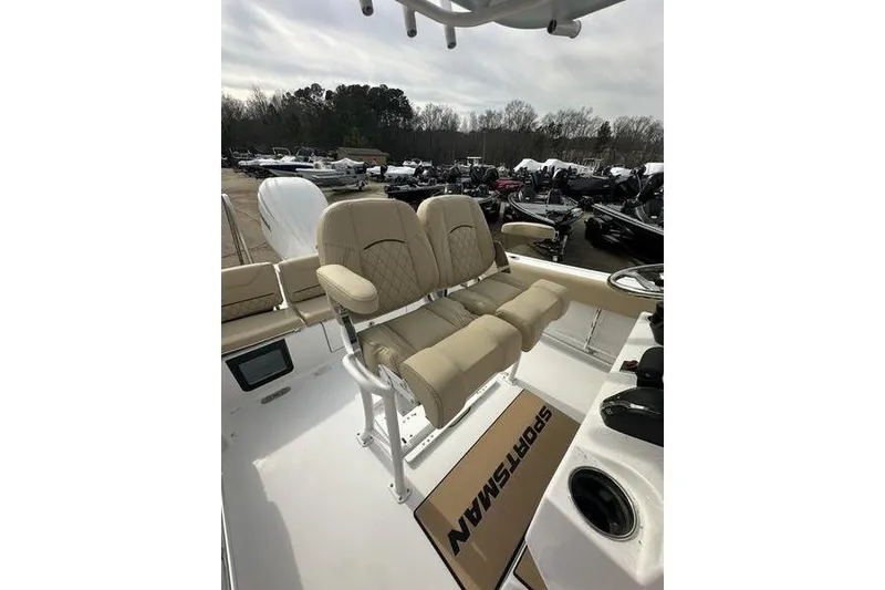 Slide: The Image of 2026 Sportsman Heritage 231 Center Console boat with beige seating and console view. - 10
