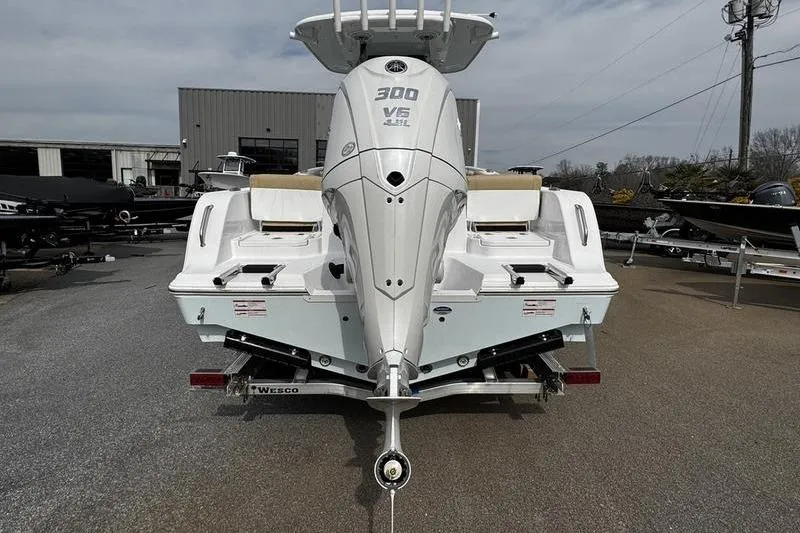 Slide: The Image of 2026 Sportsman Heritage 231 Center Console boat with powerful 300 V6 engine, rear view. - 12