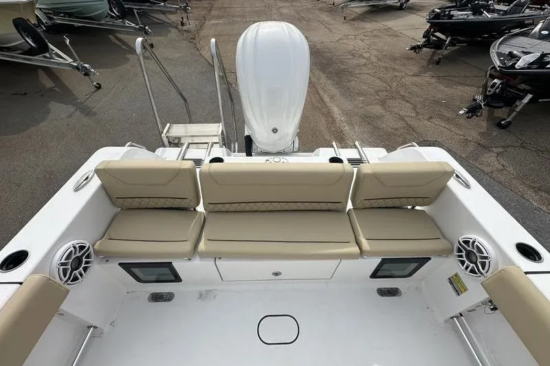 Slide: The Image of 2026 Sportsman Heritage 231 Center Console boat interior with beige seating and speakers. - 13