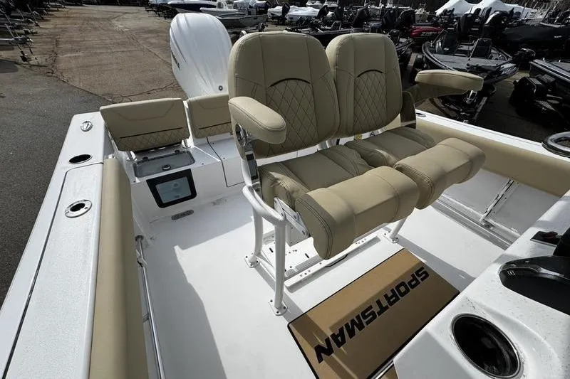Slide: The Image of 2026 Sportsman Heritage 231 Center Console boat interior with beige seating and console. - 16