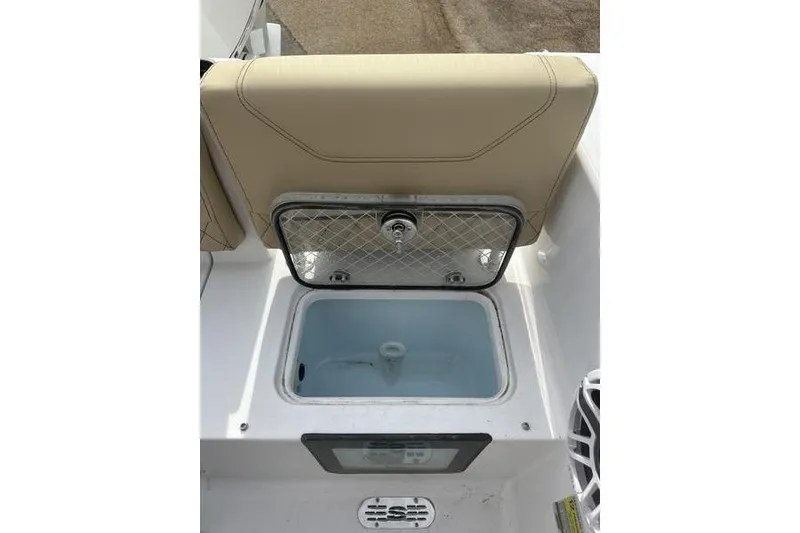 Slide: The Image of 2026 Sportsman Heritage 231 Center Console livewell with open lid and beige seating. - 17
