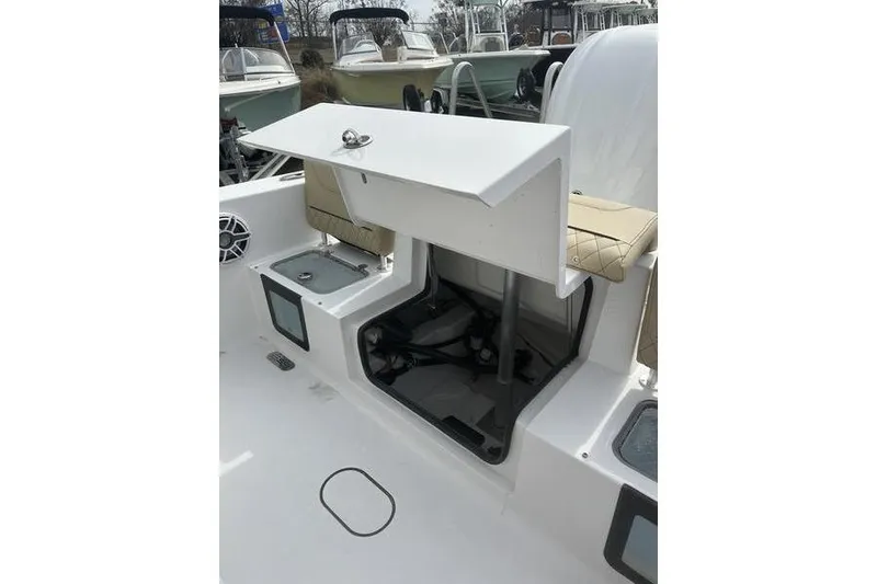 Slide: The Image of 2026 Sportsman Heritage 231 Center Console boat interior with open storage compartment. - 19
