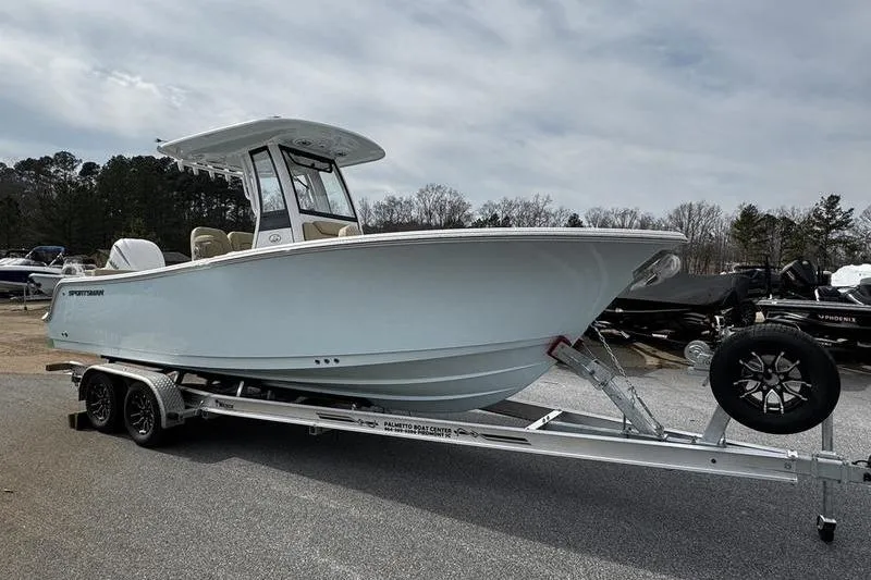 Slide: The Image of 2026 Sportsman Heritage 231 Center Console boat on trailer, parked outdoors. - 4