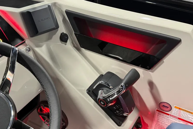 Slide: The Image of 2025 Sylvan G3 SLZ boat dashboard with steering wheel and control lever. - 13