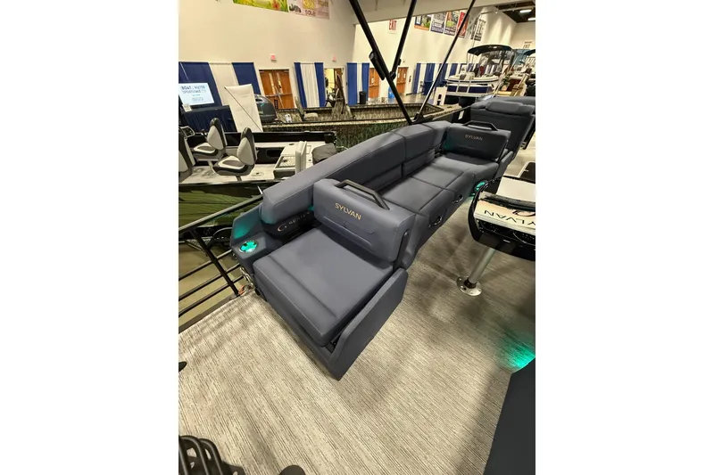 Slide: The Image of 2025 Sylvan G3 SLZ pontoon boat with luxurious seating at a boat show. - 18
