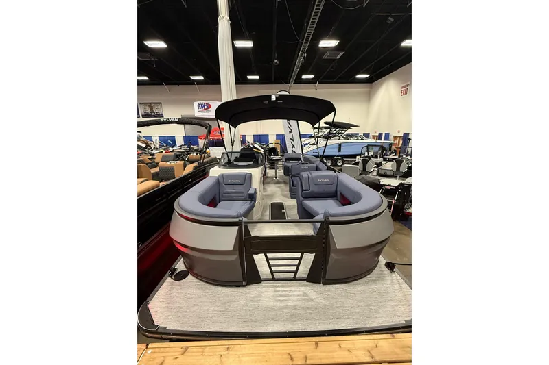Slide: The Image of 2025 Sylvan G3 SLZ pontoon boat with spacious seating and canopy in showroom. - 3