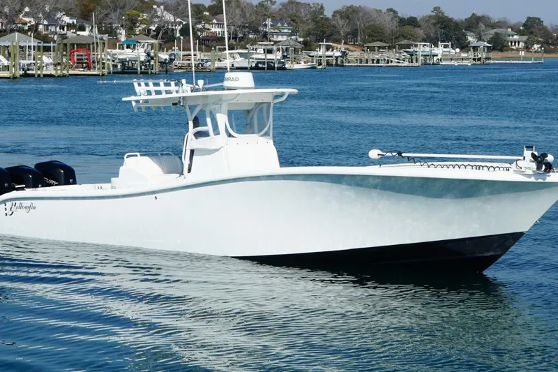 The Image of 2007 Yellowfin 36 Offshore boat on calm water near a marina. - 1