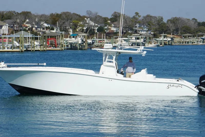 Slide: The Image of 2007 Yellowfin 36 Offshore boat on calm water near a marina. - 11