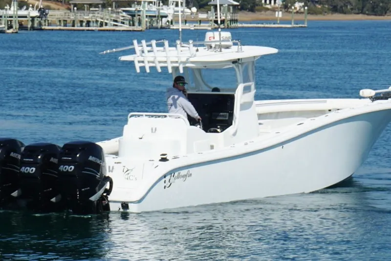 Slide: The Image of 2007 Yellowfin 36 Offshore boat with triple Mercury 400 engines on blue water. - 12