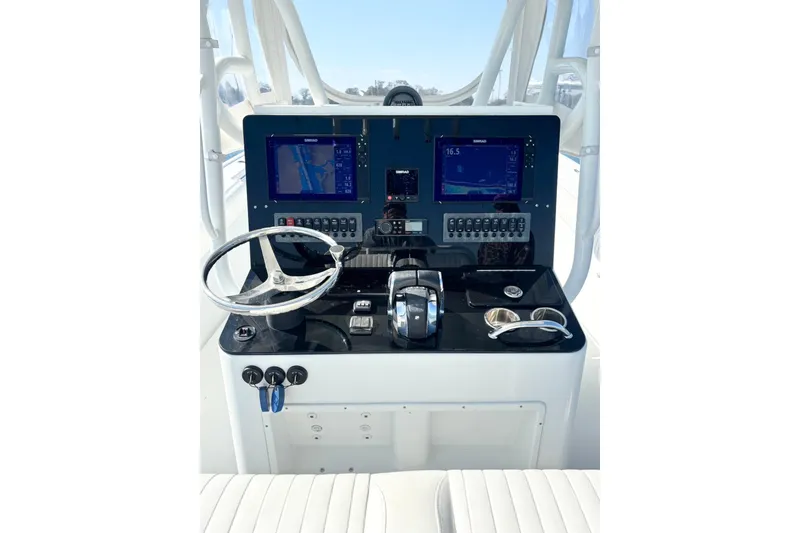 Slide: The Image of 2007 Yellowfin 36 Offshore boat dashboard with navigation screens and steering wheel. - 13