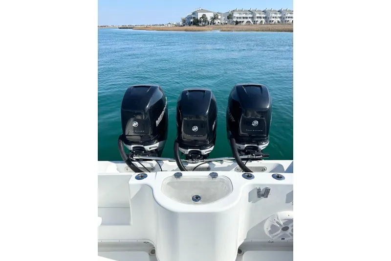 Slide: The Image of 2007 Yellowfin 36 Offshore boat with triple Mercury outboard engines on calm water. - 15