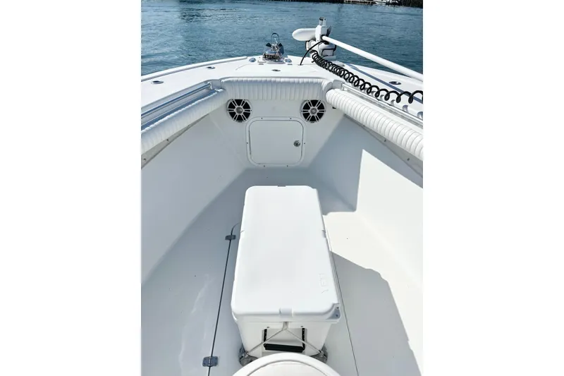 Slide: The Image of 2007 Yellowfin 36 Offshore boat interior with seating and storage, on calm water. - 17