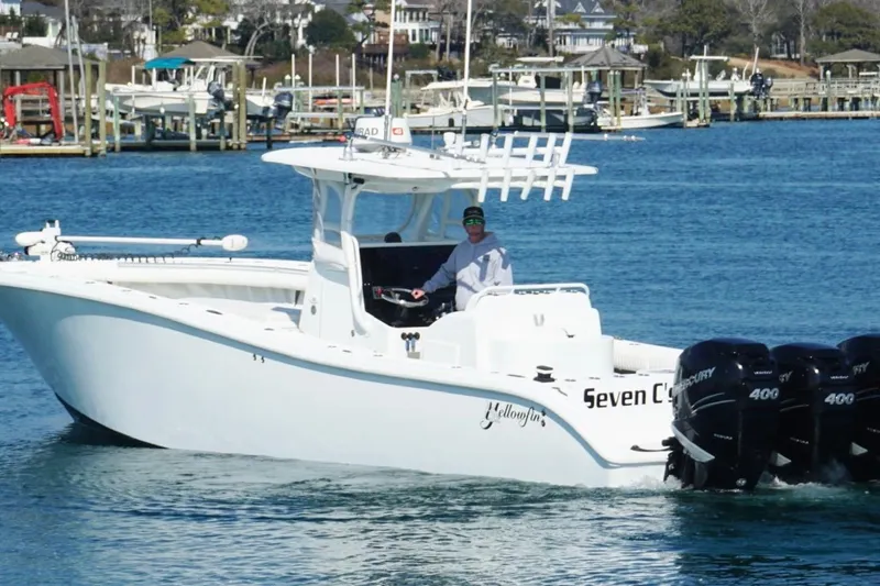 Slide: The Image of 2007 Yellowfin 36 Offshore boat with triple engines cruising in a marina. - 5