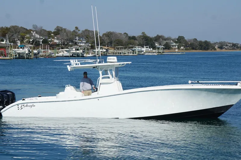 Slide: The Image of 2007 Yellowfin 36 Offshore boat on calm water near a marina. - 6