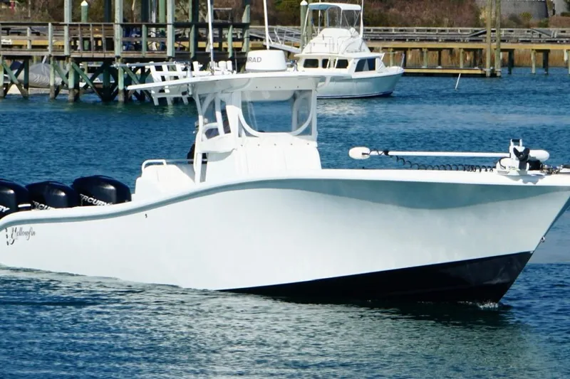 Slide: The Image of 2007 Yellowfin 36 Offshore boat docked in marina, featuring multiple outboard engines. - 7