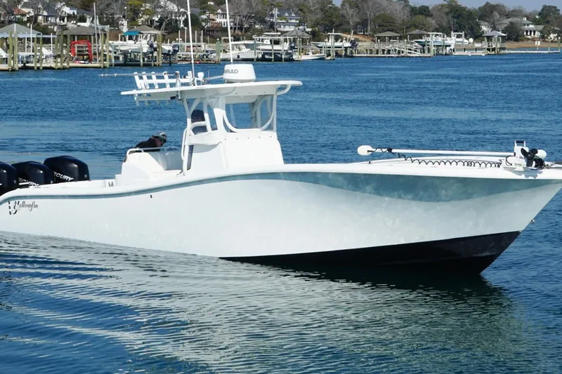 Slide: The Image of 2007 Yellowfin 36 Offshore boat on calm water near a marina. - 9