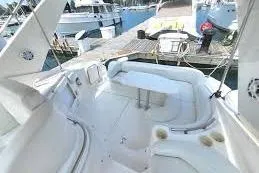 Slide: The Image of 1995 Silverton 361 Express yacht interior with white seating at marina. - 5