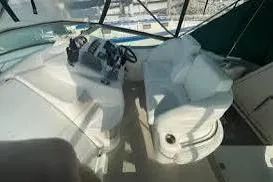 Slide: The Image of 1995 Silverton 361 Express boat interior with white seating and control panel. - 7