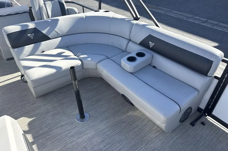 Slide: The Image of 2023 Viaggio Del Mar 18F boat interior with gray seating and cup holders. - 10