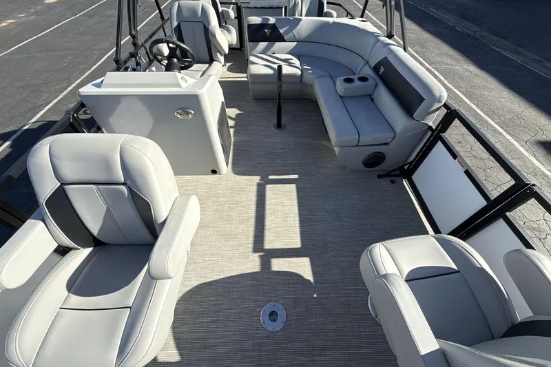 Slide: The Image of 2023 Viaggio Del Mar 18F pontoon boat interior with plush seating and steering console. - 12