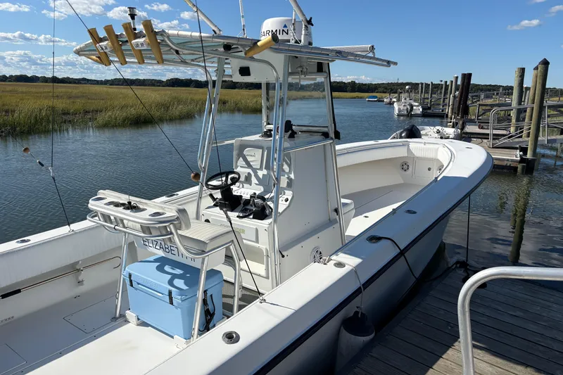 Slide: The Image of 2001 Contender 31 Open boat docked by a scenic river with fishing gear. - 1