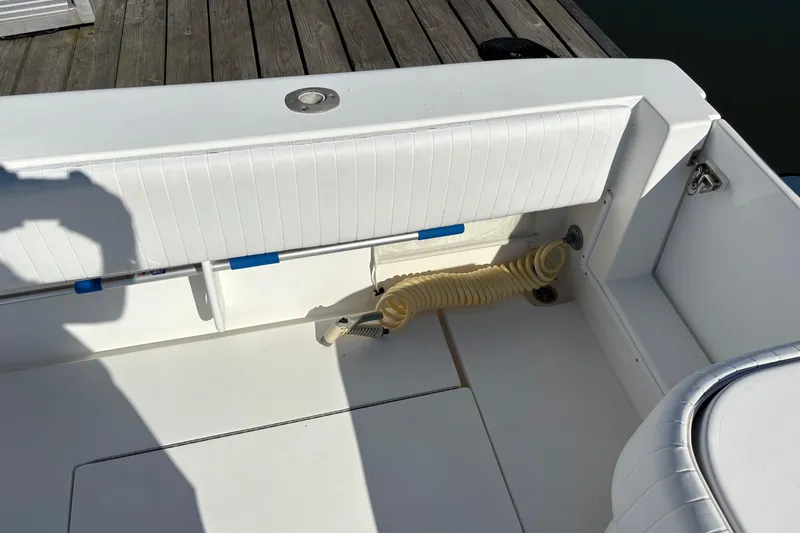 Slide: The Image of 2001 Contender 31 Open boat interior with white seating and coiled hose. - 10
