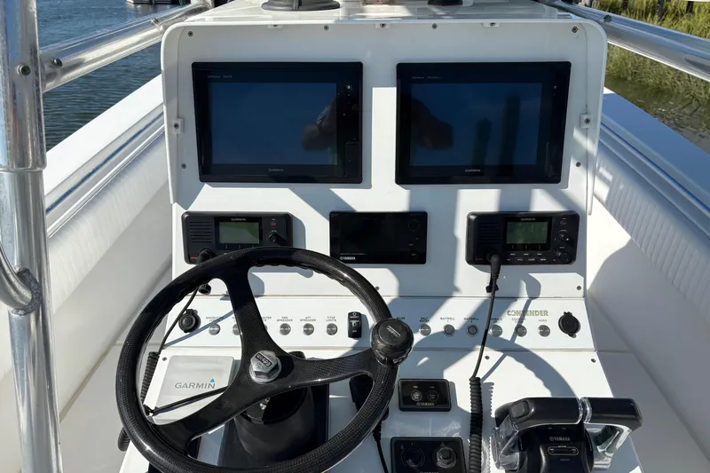 Slide: The Image of 2001 Contender 31 Open boat dashboard with Garmin navigation and control systems. - 13