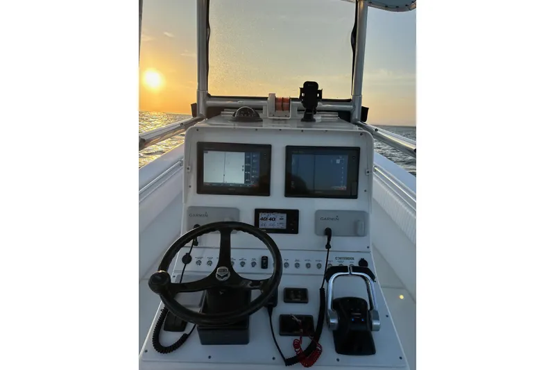 Slide: The Image of 2001 Contender 31 Open boat console with Garmin displays at sunset on the water. - 16