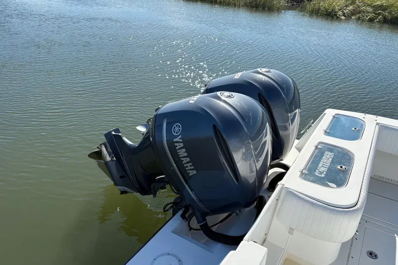 Slide: The Image of 2001 Contender 31 Open boat with Yamaha outboard engines on calm water. - 3