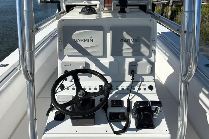 Slide: The Image of 2001 Contender 31 Open boat dashboard with Garmin navigation system and steering wheel. - 4