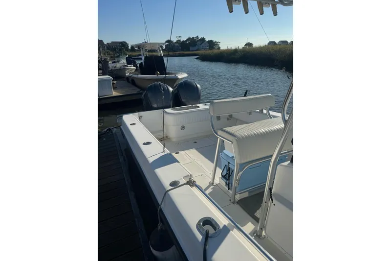 Slide: The Image of 2001 Contender 31 Open boat docked by a serene waterfront. - 5