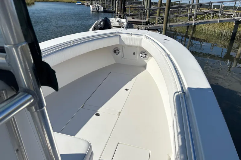 Slide: The Image of 2001 Contender 31 Open boat docked, showcasing spacious deck and sleek design. - 6