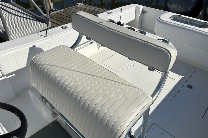 Slide: The Image of 2001 Contender 31 Open boat interior with white cushioned seating and rod holders. - 8