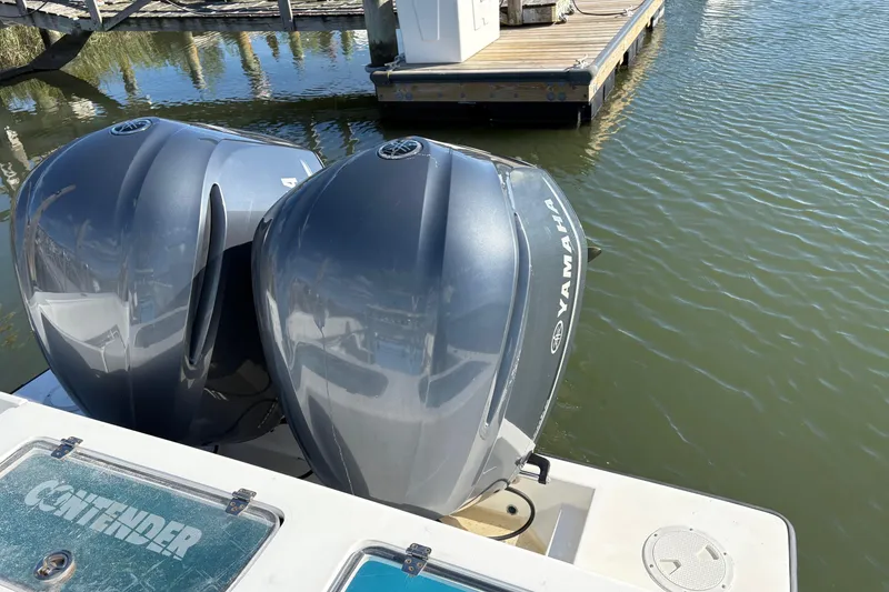 Slide: The Image of 2001 Contender 31 Open boat with dual Yamaha outboard motors docked on calm water. - 9