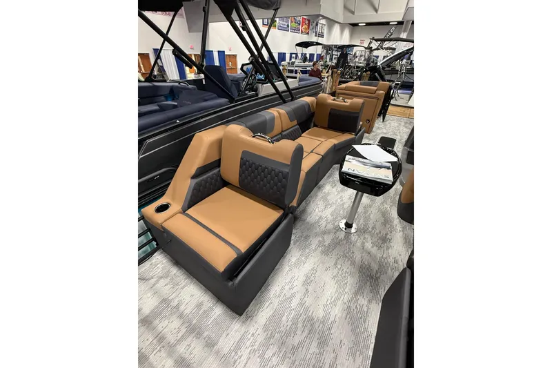 Slide: The Image of Luxurious interior of 2026 Sylvan L3 SLZ pontoon boat with tan and black seating. - 11