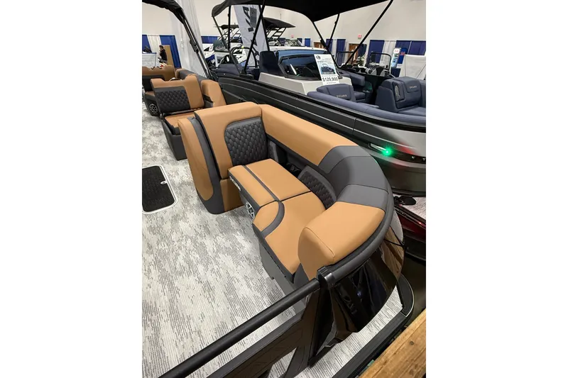 Slide: The Image of Luxurious seating on 2026 Sylvan L3 SLZ pontoon boat, featuring tan and gray upholstery. - 3