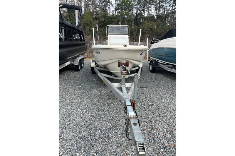 Slide: The Image of 2019 Scout 175 Sportfish boat on trailer, parked on gravel lot. - 5