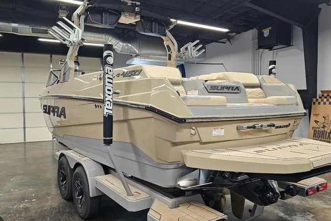 Slide: The Image of 2026 Supra SL boat in a showroom, featuring a sleek design and advanced wakeboard tower. - 10